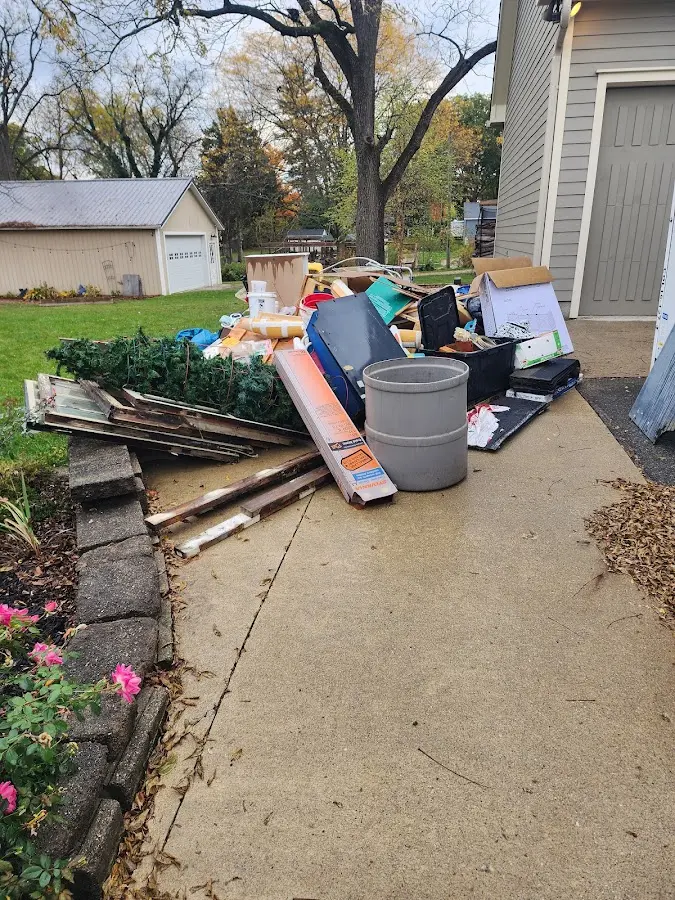Dumpster being loaded with debris for Estate Cleanout Dumpster Rental in Ridgemark